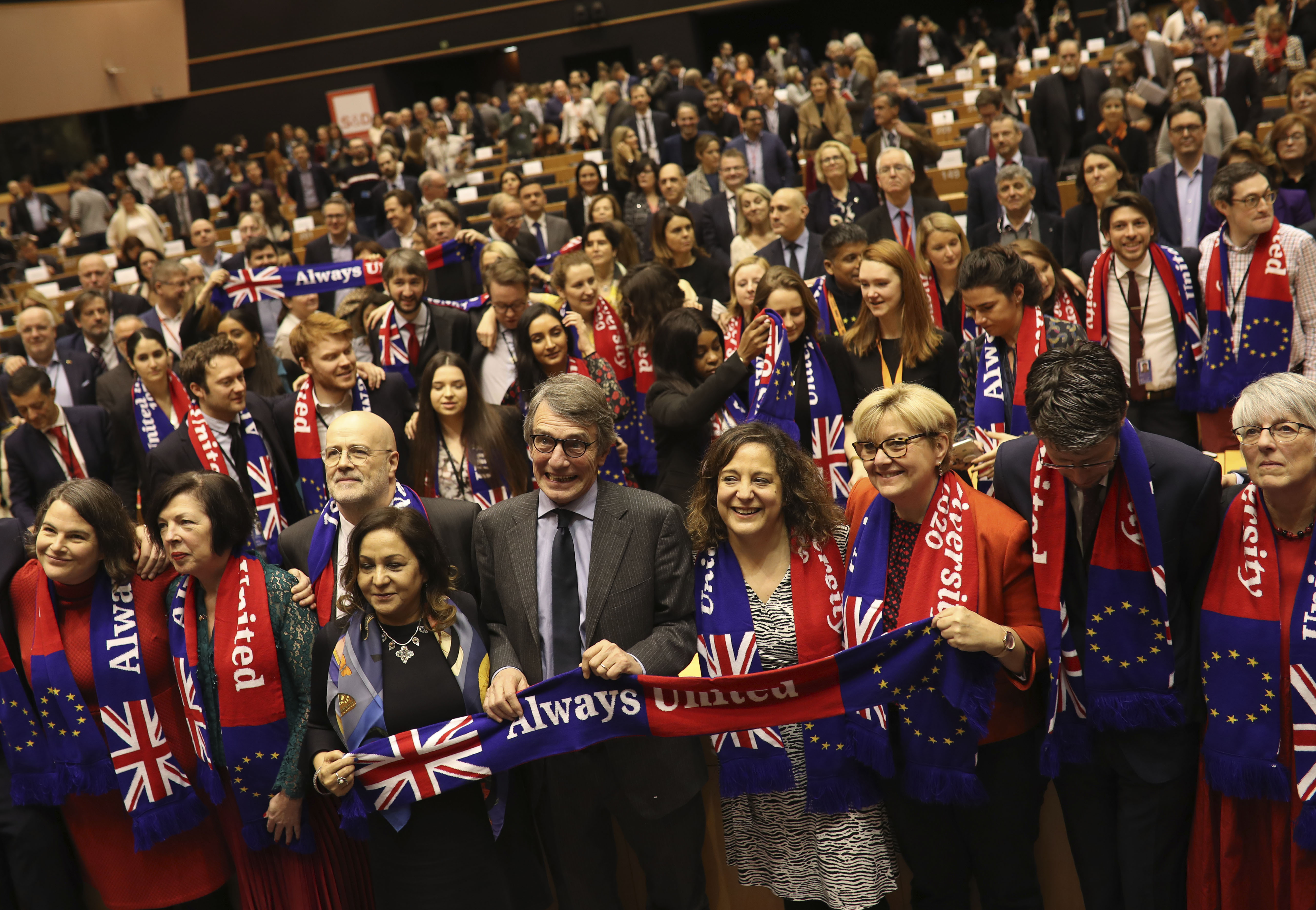 European Parliament President David Sassoli, center, stands with other British MEP's and members of the political group Socialist and Democrats as they participate in a ceremony prior to the vote on the UK's withdrawal from the EU at the European Parliament in Brussels