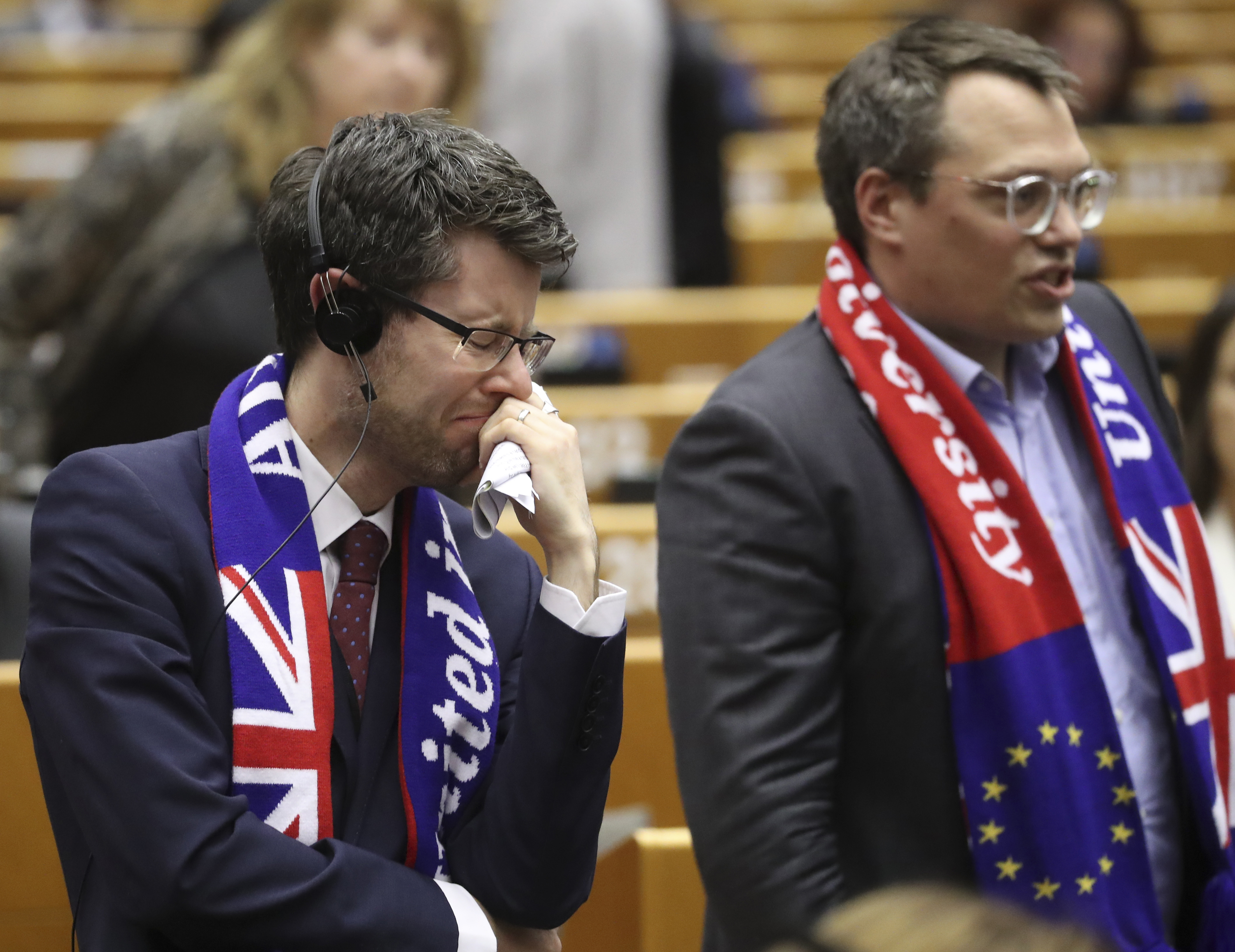 MEP's wear banners and react after a vote on the UK's withdrawal from the EU, the final legislative step in the Brexit proceedings, during the plenary session at the European Parliament in Brussels