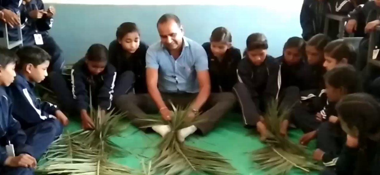 School children learning how to make sweep