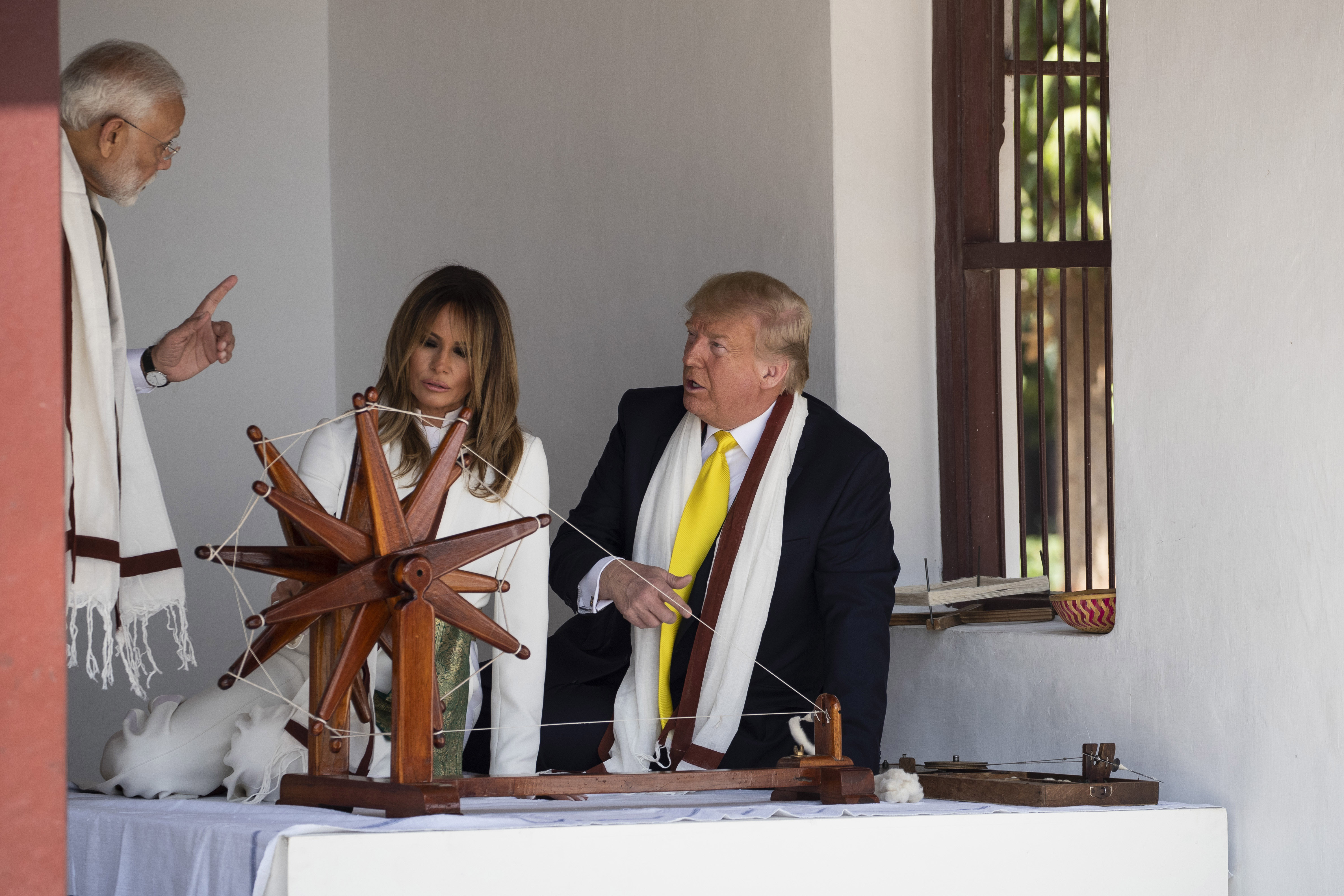 US President Donald Trump with First Lady Melania Trump and Prime Minister Narendra Modi, look at a Charkha or a spinning wheel, during a tour of Gandhi Ashram in Ahmedabad on Monday.