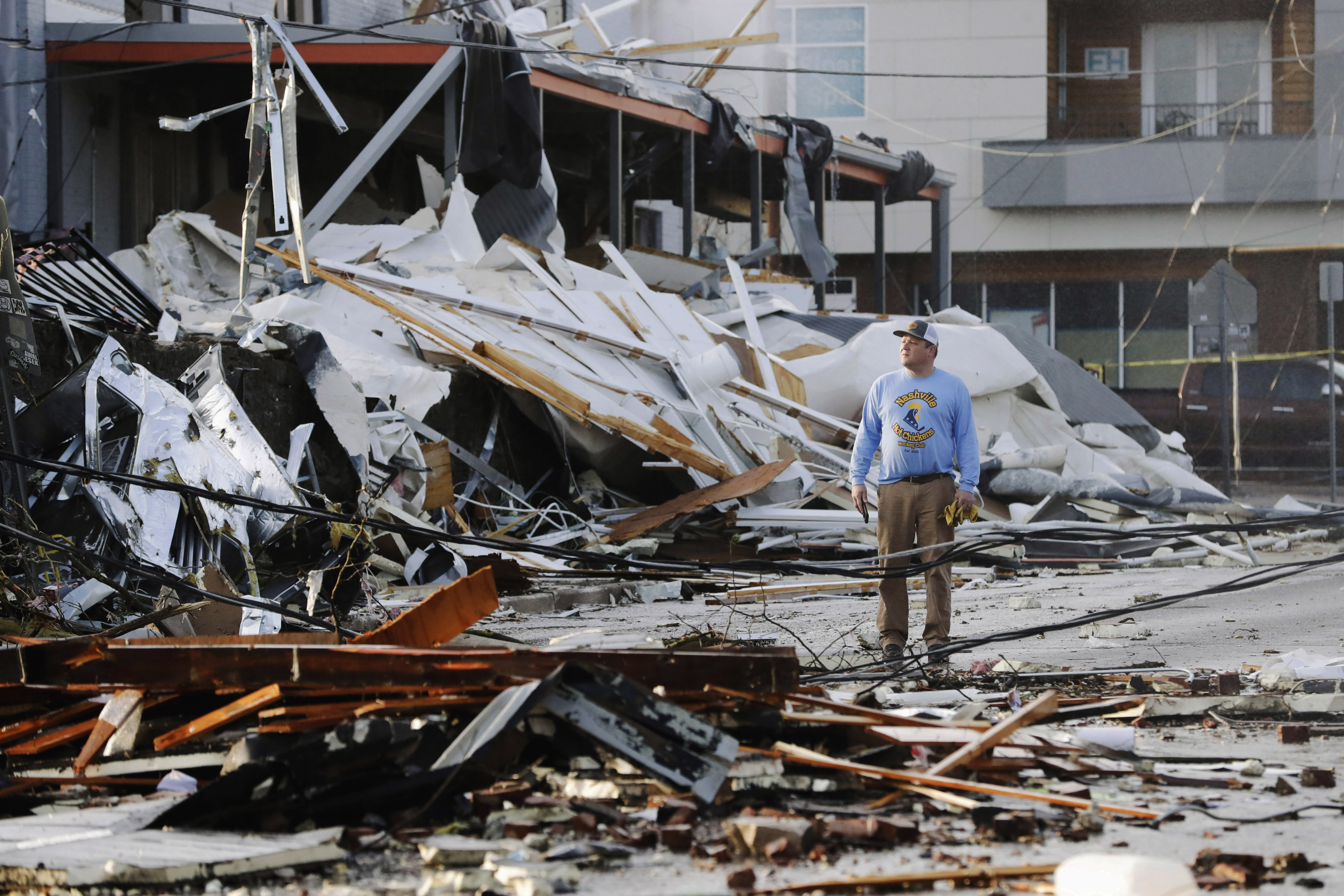 A man looks over buildings destroyed by storms Tuesday in Nashville, Tenn.