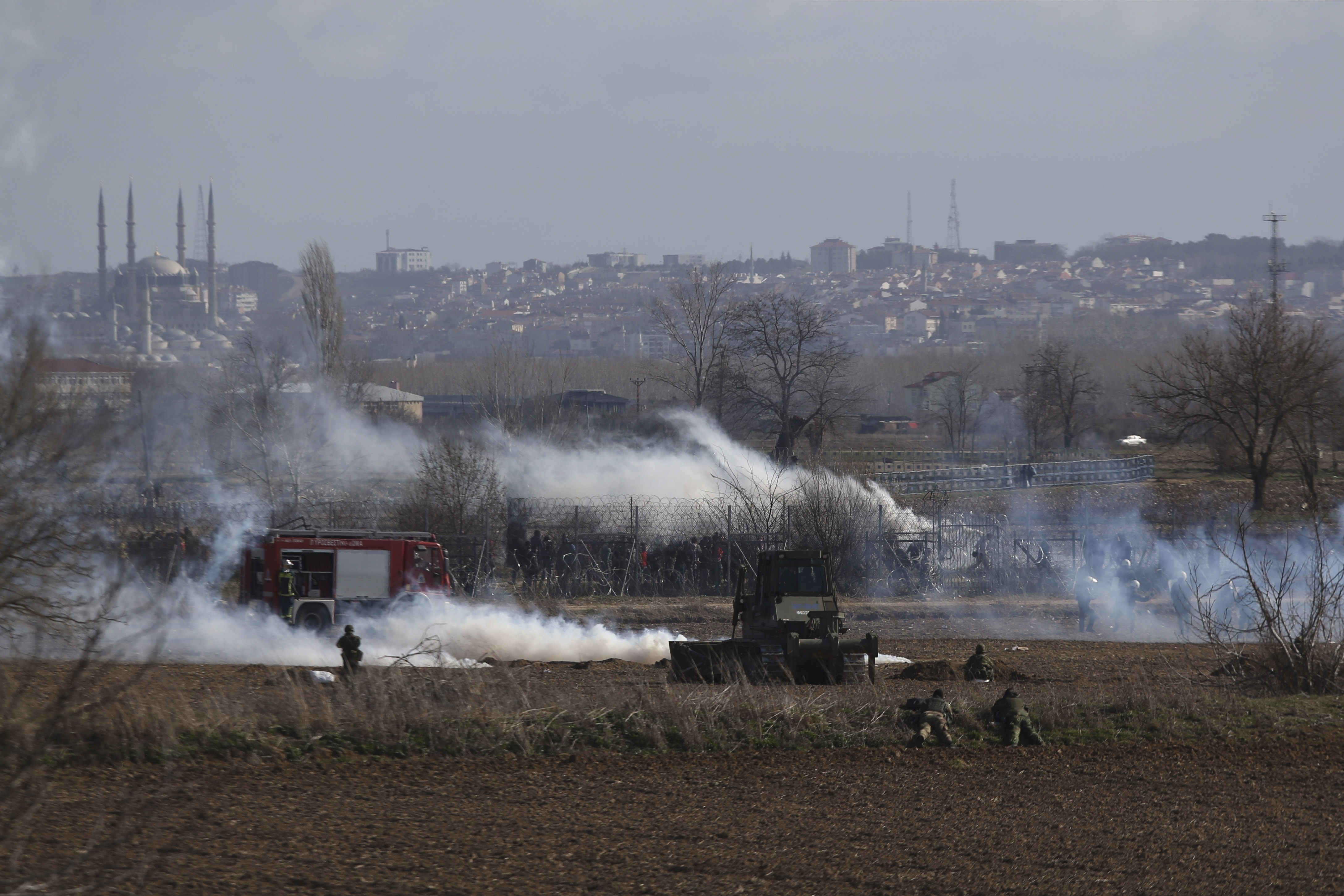 Greek army take positions as migrants gather at a border fence on the Turkish side, during clashes at the Greek-Turkish border in Kastanies, Evros region, on Saturday.