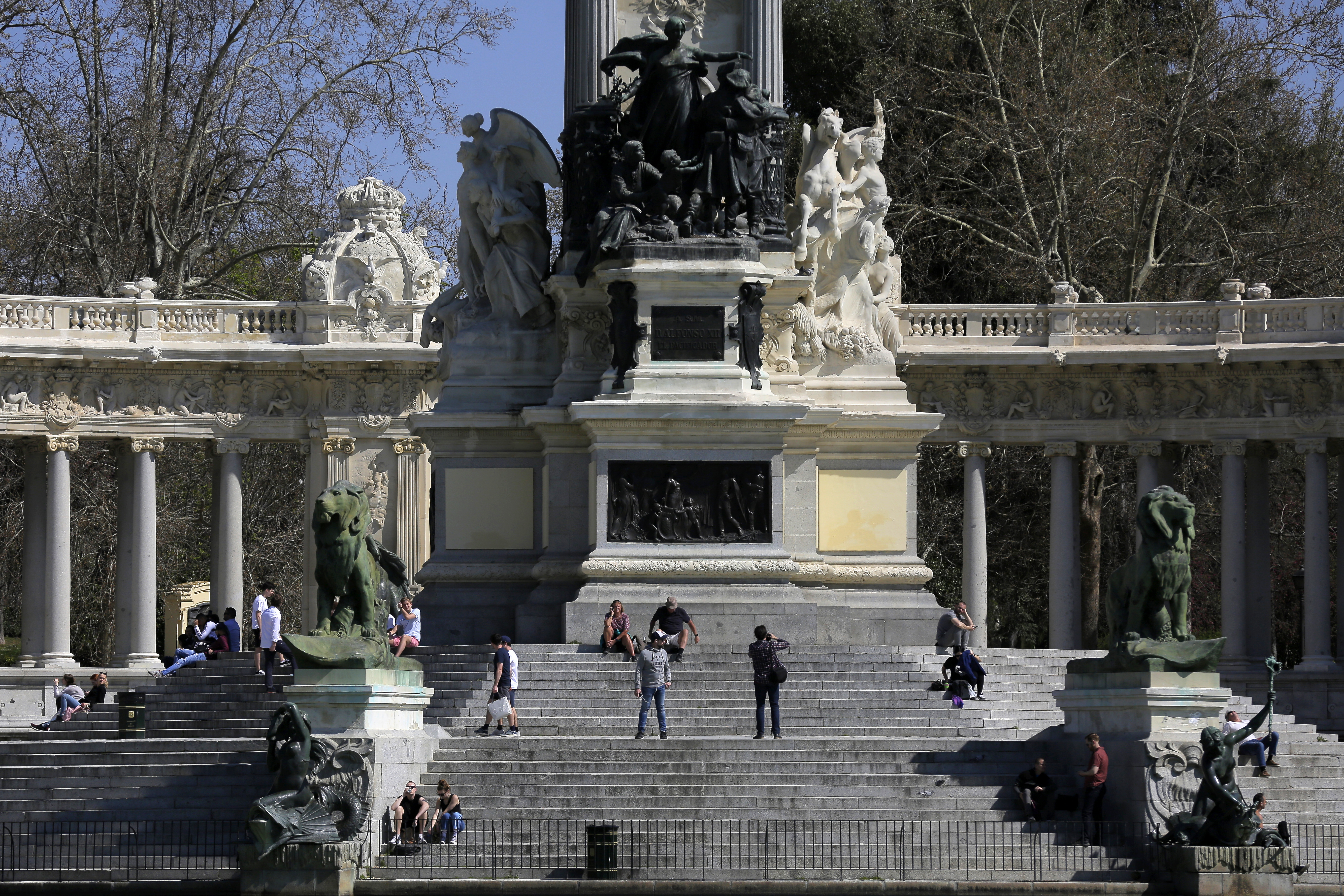 People enjoy the sun at the retiro park in Madrid, Spain, on Saturday.