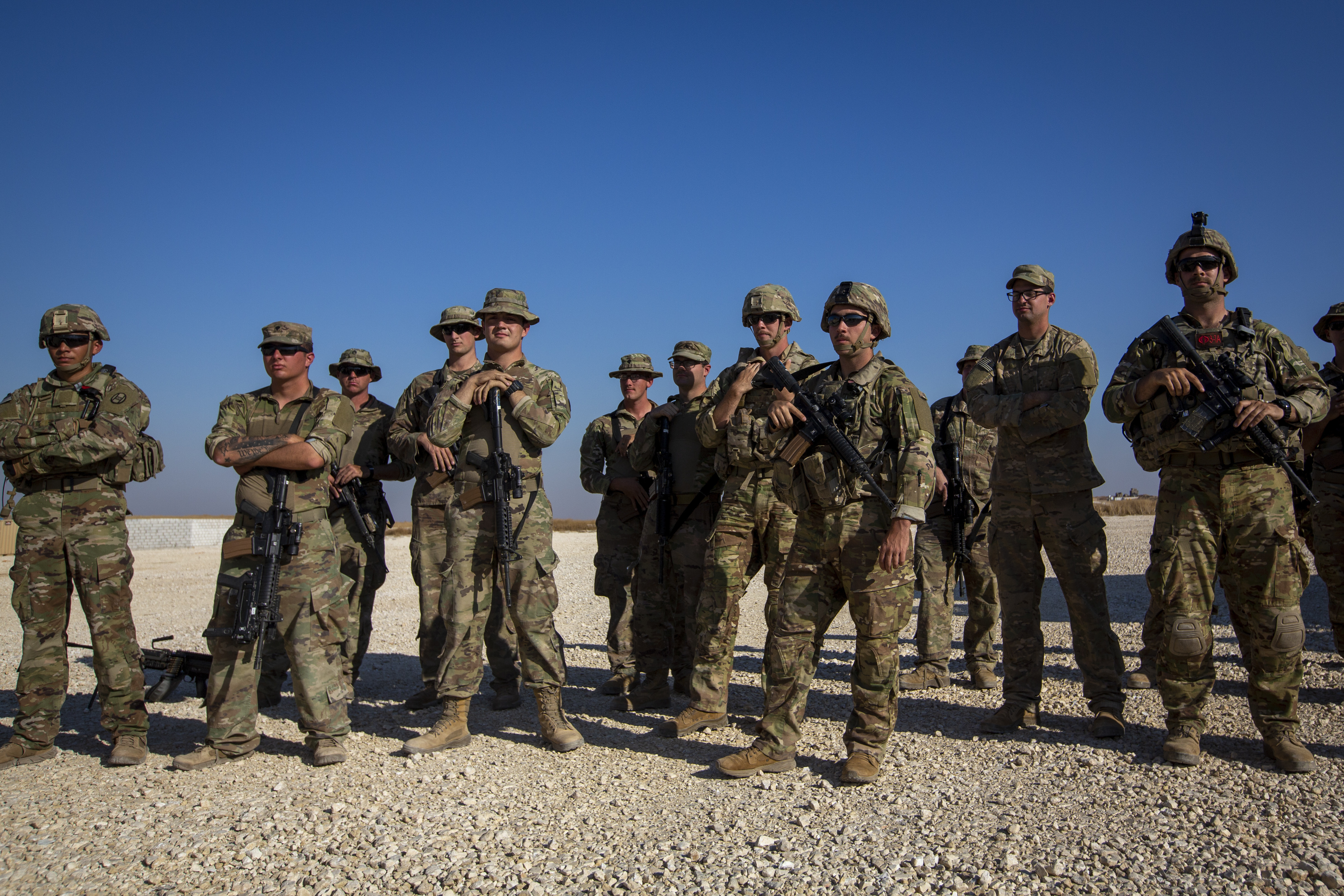 Crewmen of Bradley fighting vehicles stand guard at a U.S. military base in Northeastern Syria.