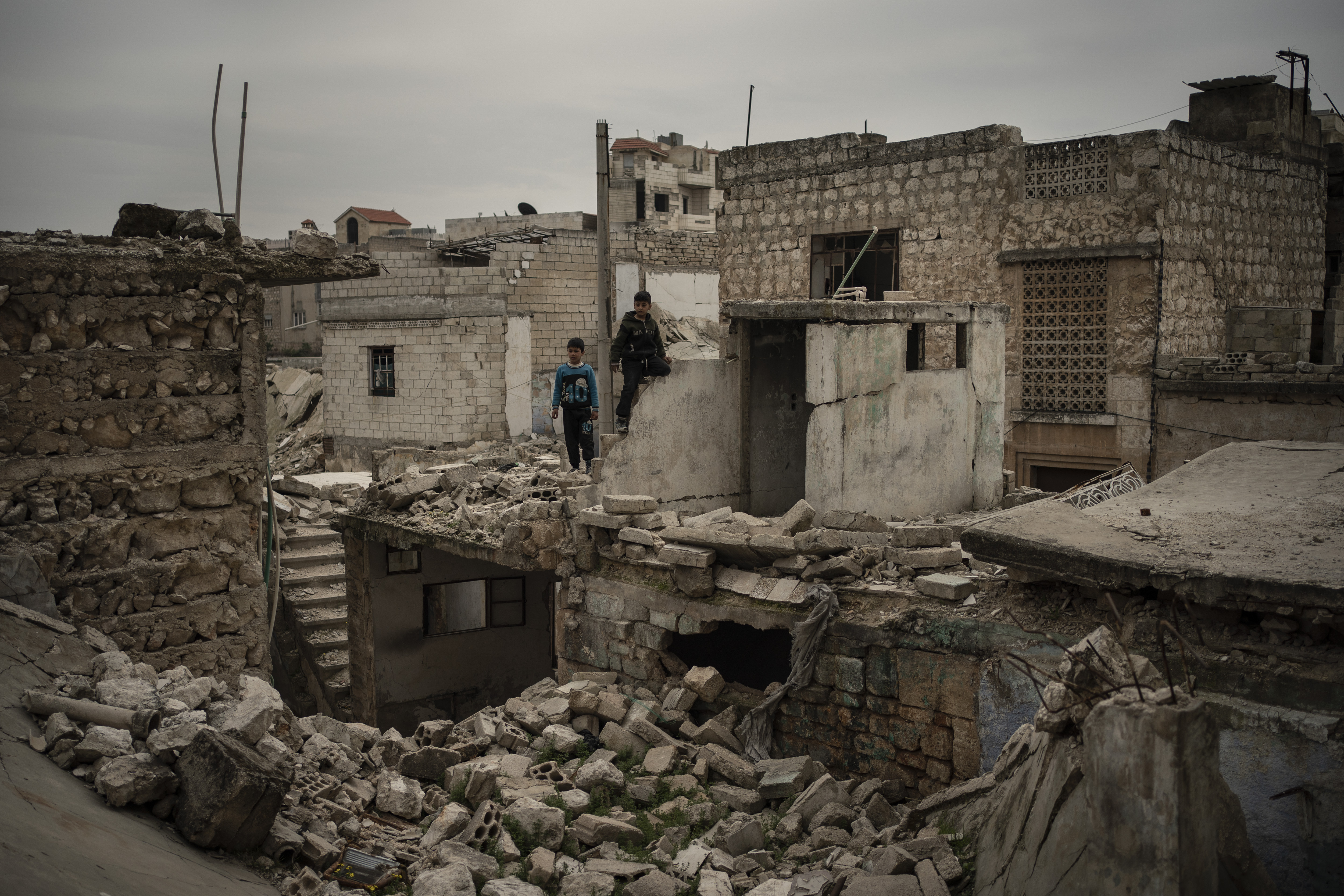 Children play on the rubble of houses destroyed by airstrikes, in Idlib, Syria.