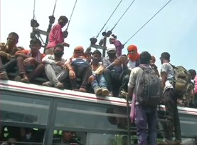 People travelling from buses due to cancellation of passenger trains