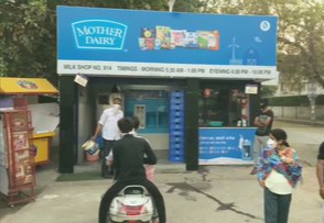 People gathered outside a dairy shop to buy milk in Gurugram