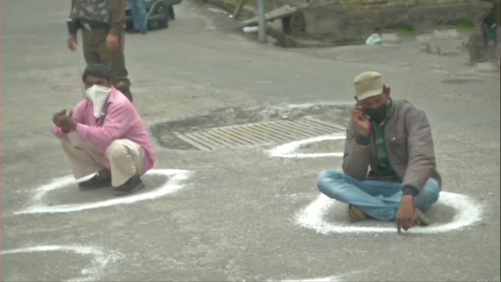 eople who were flouting restrictions that have been imposed amid lockdown, made to sit in circles drawn to maintain social distance, in Jammu.