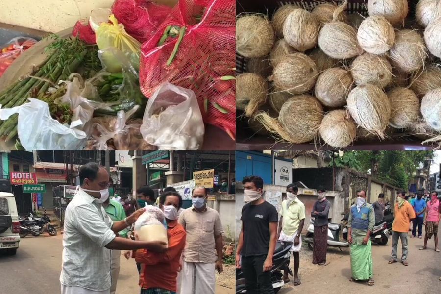 Municipality officials distribute food material among the migrant labourers