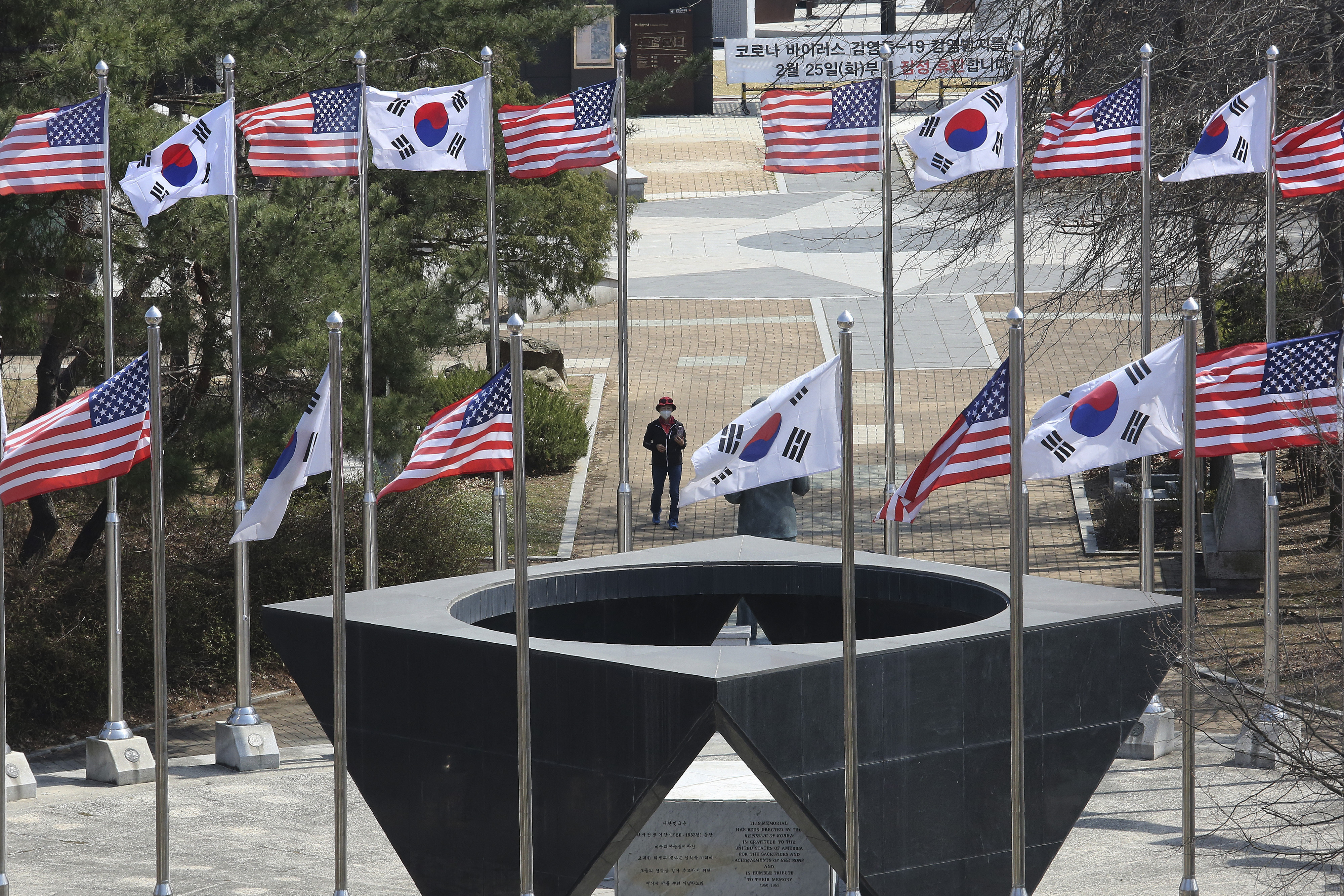 A woman wearing a face mask to help protect against the coronavirus visits a monument dedicated to the United States forces in the Korean War at Imjingak in Paju