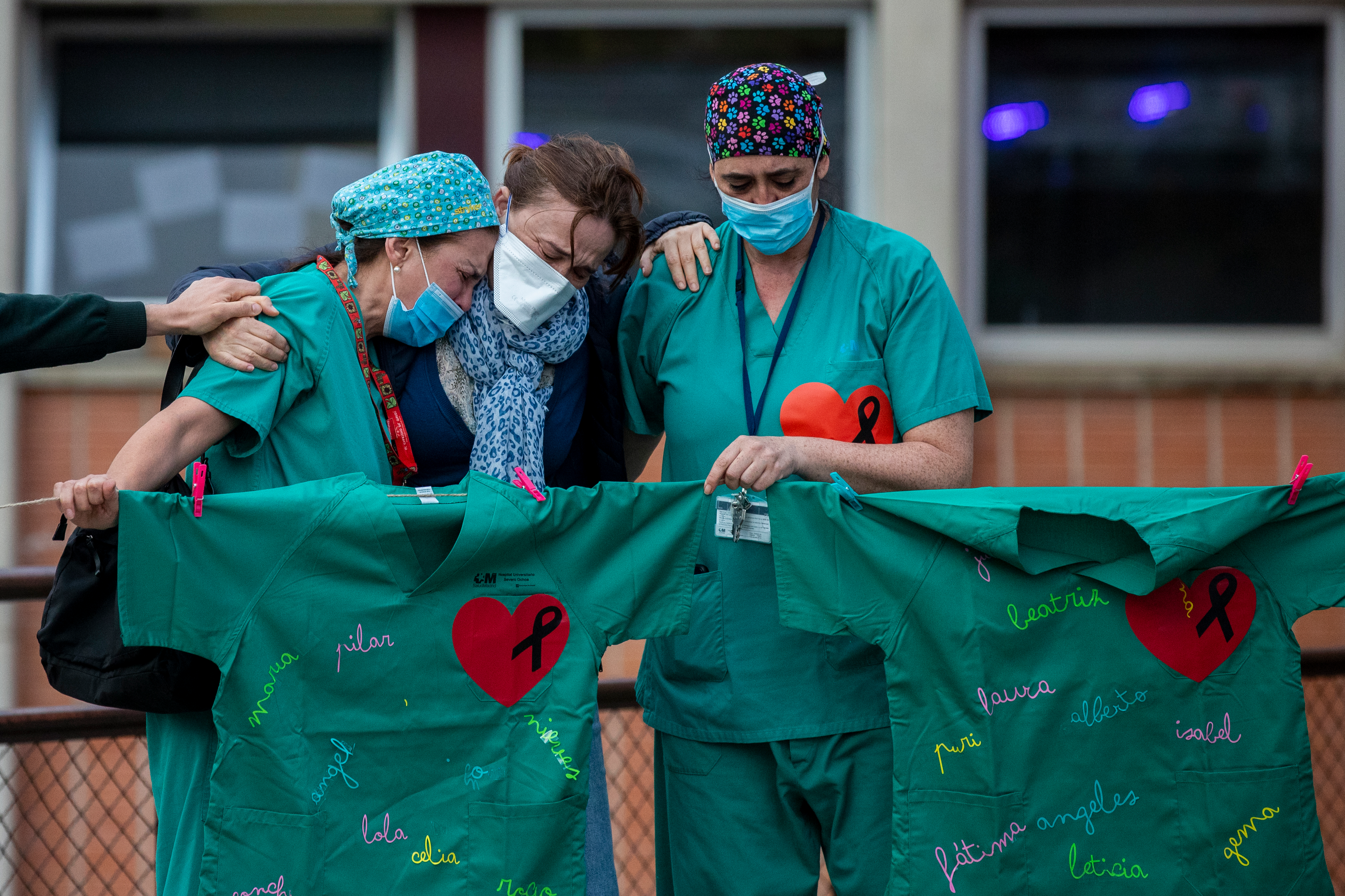 Health workers cry during a memorial for their co-worker Esteban, a male nurse that died of the coronavirus disease, at the Severo Ochoa Hospital in Leganes in Leganes, Spain