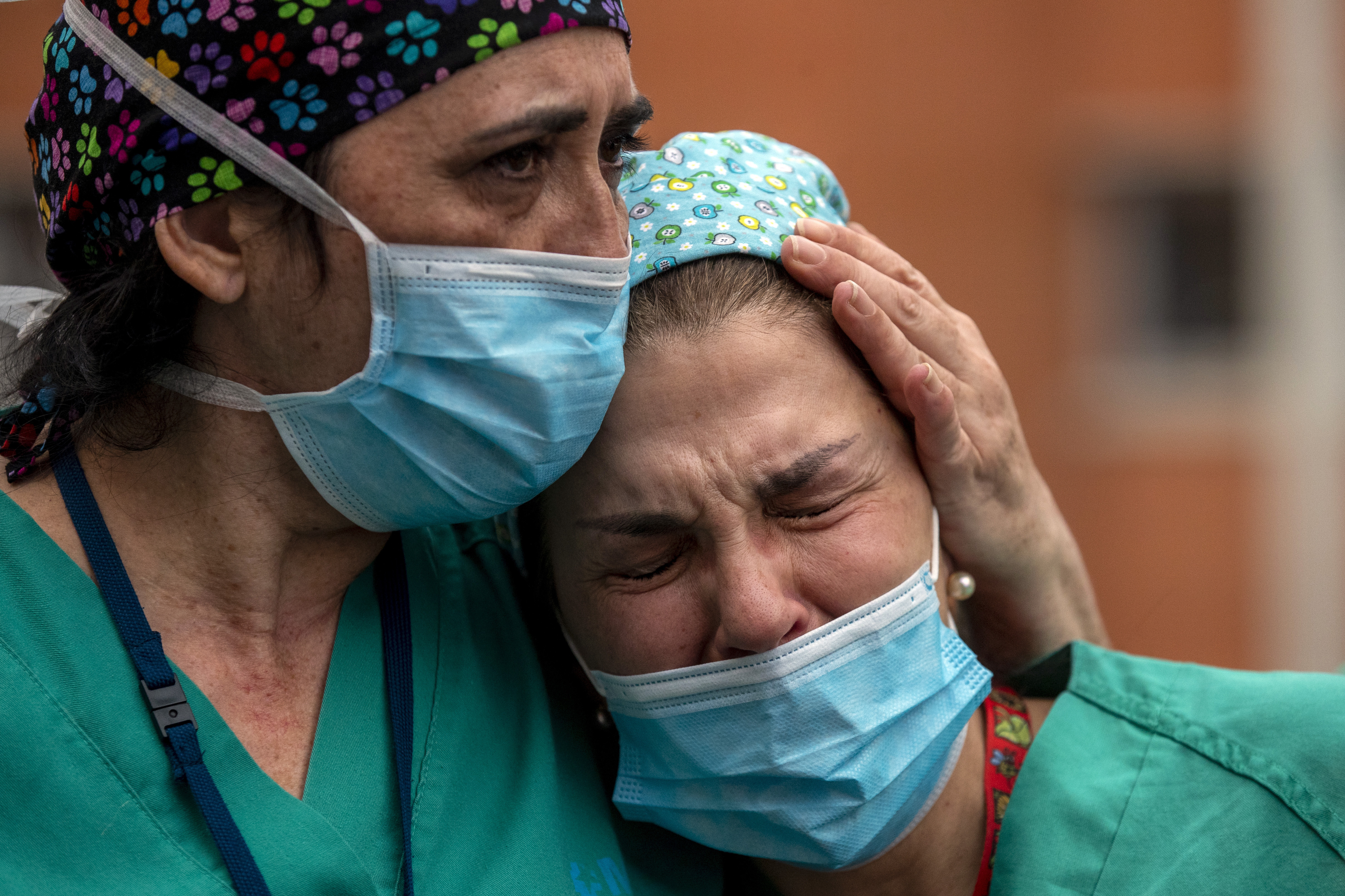 Health workers cry during a memorial for their co-worker Esteban, a male nurse that died of the coronavirus disease, at the Severo Ochoa Hospital in Leganes in Leganes, Spain