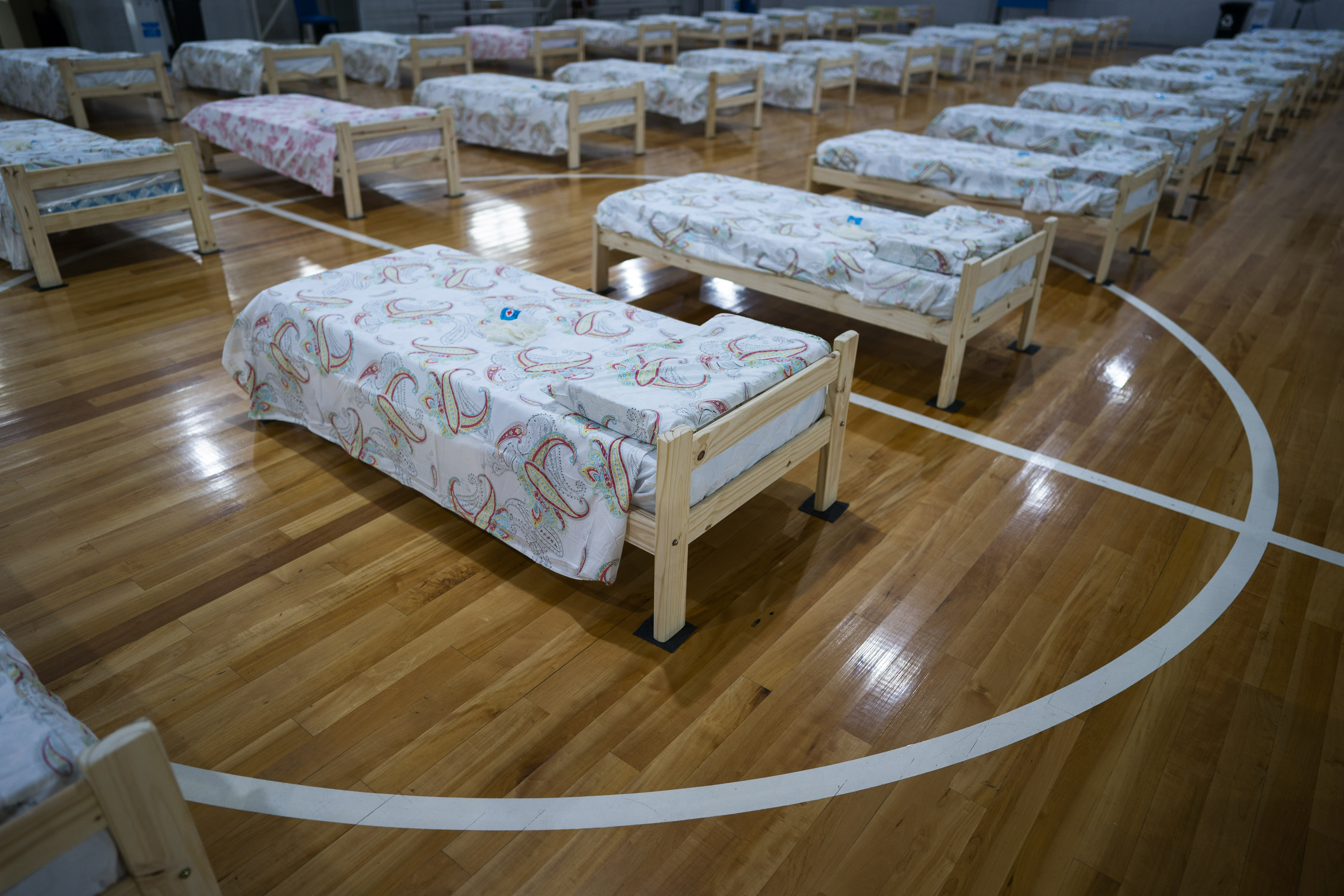 Cots, to be used by people infected with the new coronavirus, fill an indoor soccer court at the Argentine Football Association training facility in the outskirts of Buenos Aires, Argentina