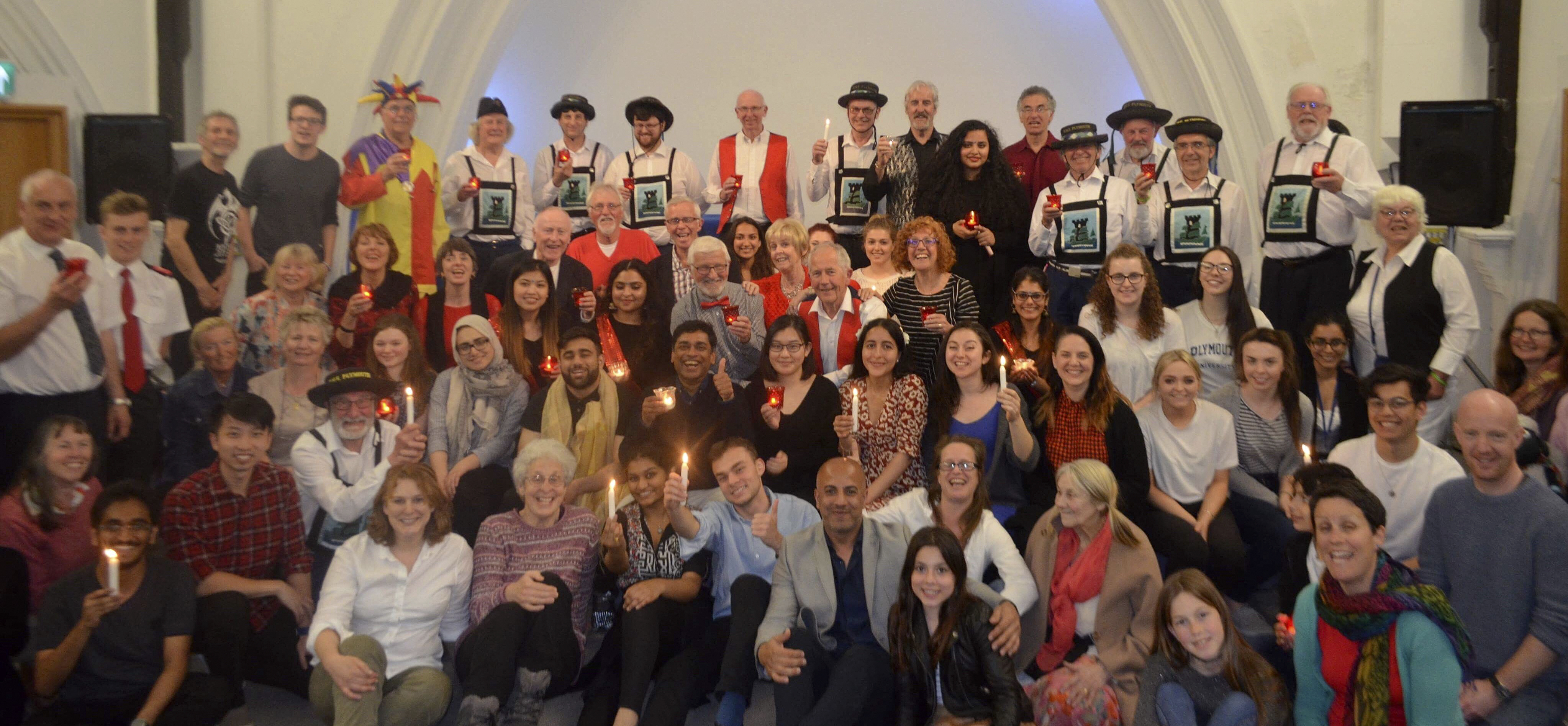 Dr. Poorna Gunasekera, center, poses for a photo with a combined group of performers from multiple faculties of Plymouth University and community members from Devon and Cornwall, who came together to stage a surprise 