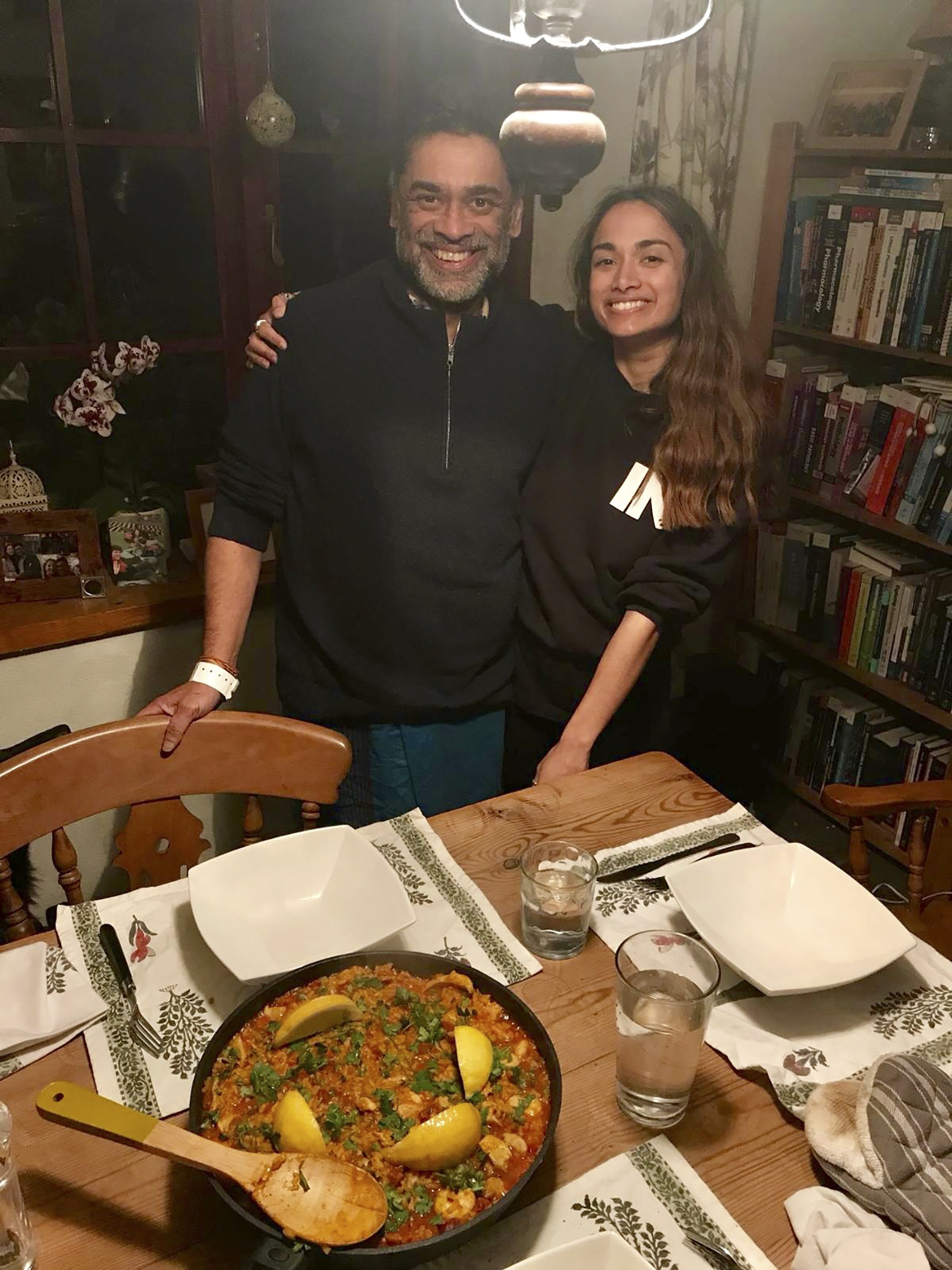 Dr. Poorna Gunasekera poses for a photo with his daughter Saki with the 'Paella' dish prepared as his welcome home dinner in the village of Filham, Devon, England after returning from hospital.