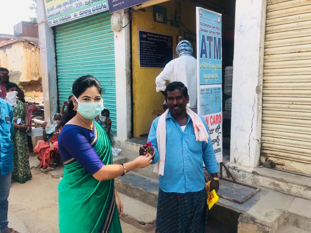 women sarpanch distributed flowers to people