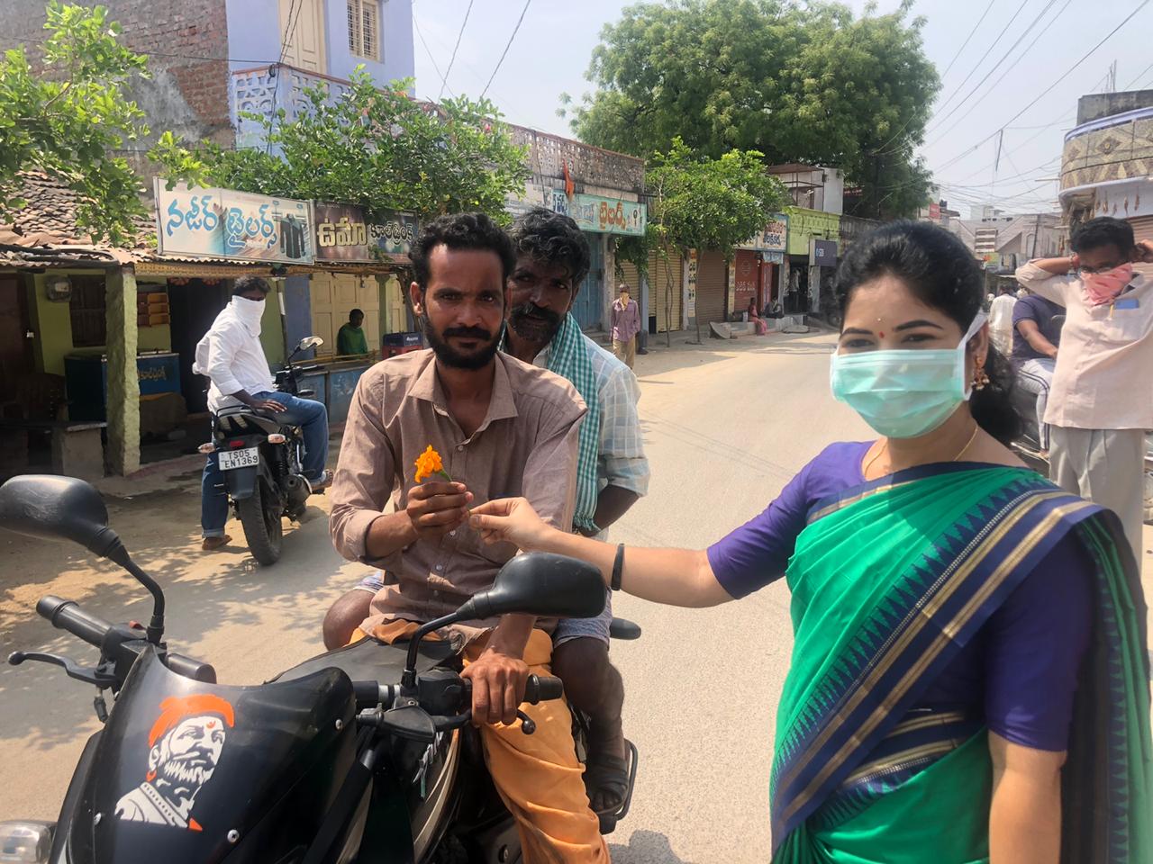 women sarpanch distributed flowers to people