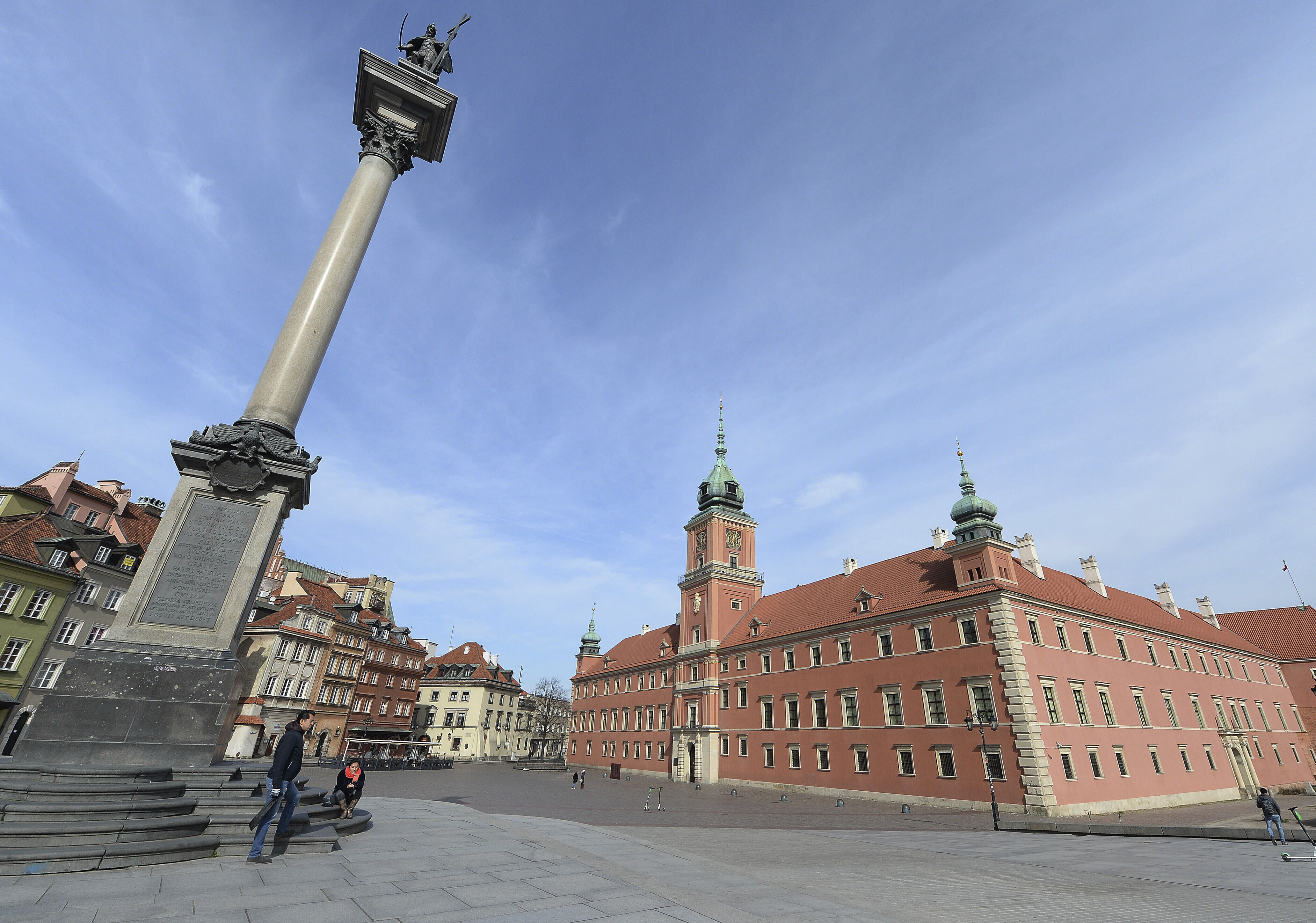 In this Monday, March 16, 2020 file photo, the Castle Square in the center of the city is nearly empty in Warsaw, Poland.