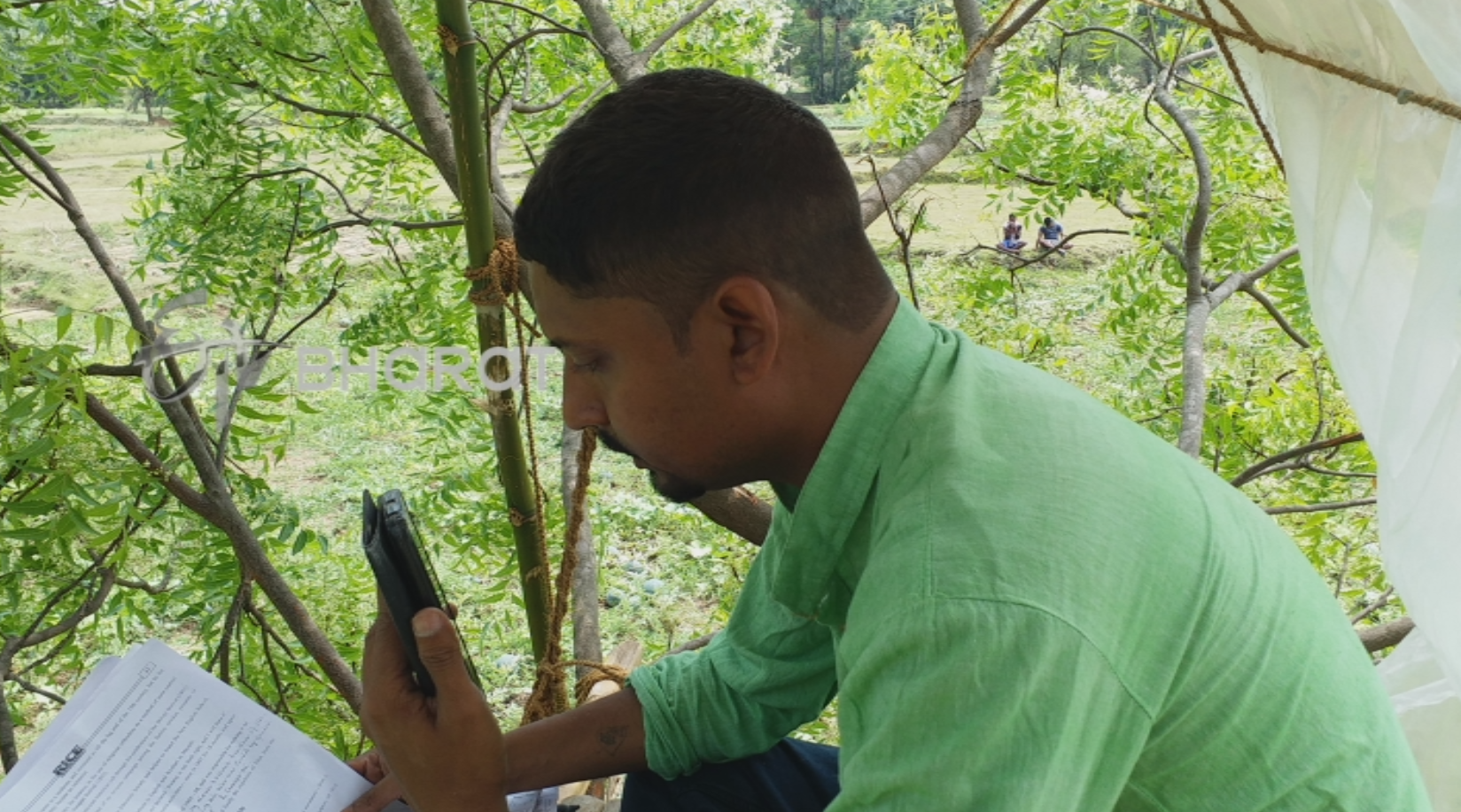 Teacher taking online clases atop a tree in Bankura