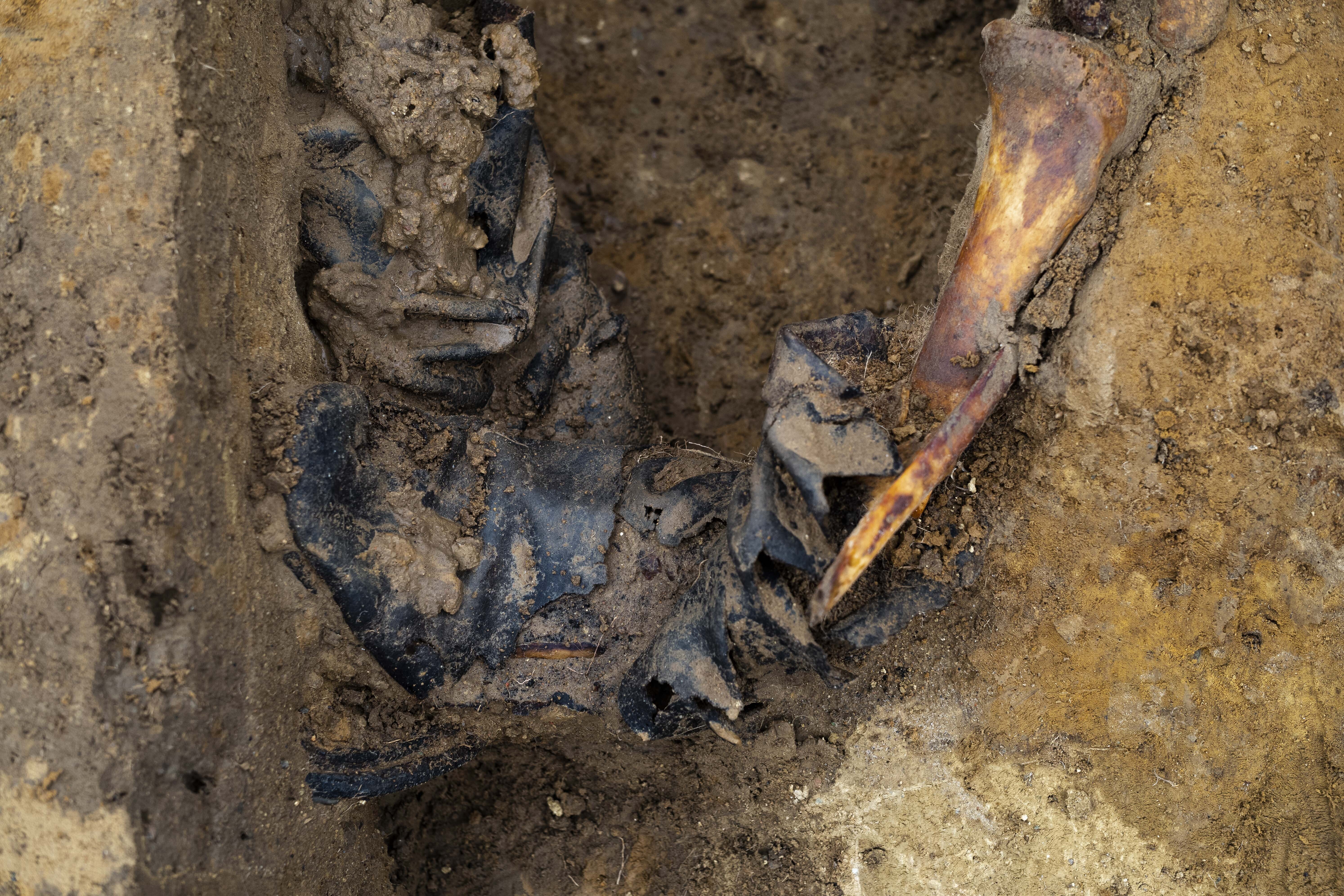 A view of bones stuck in a boot, part of the remains of a Soviet soldier exhumed, during a search for fallen WWII soldiers near the village of Klessin, in Germany