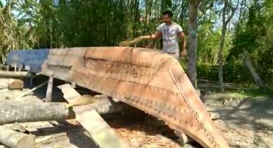 river people in assam preparing boat to fight against flood