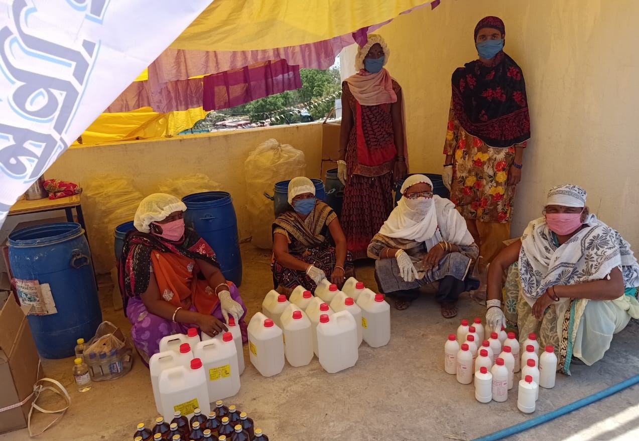 women making sanitizer