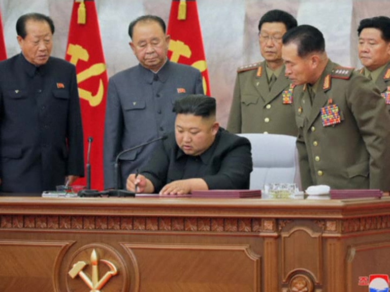 Kim signing a military strategy