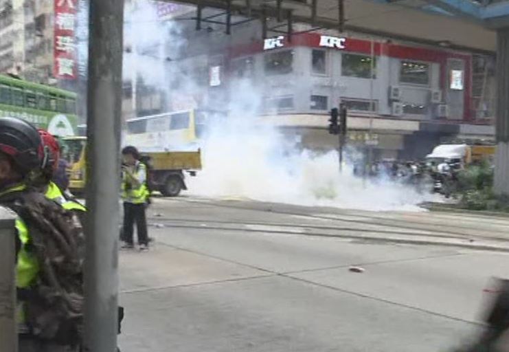 Hong Kong police fire volleys of tear gas at protesters