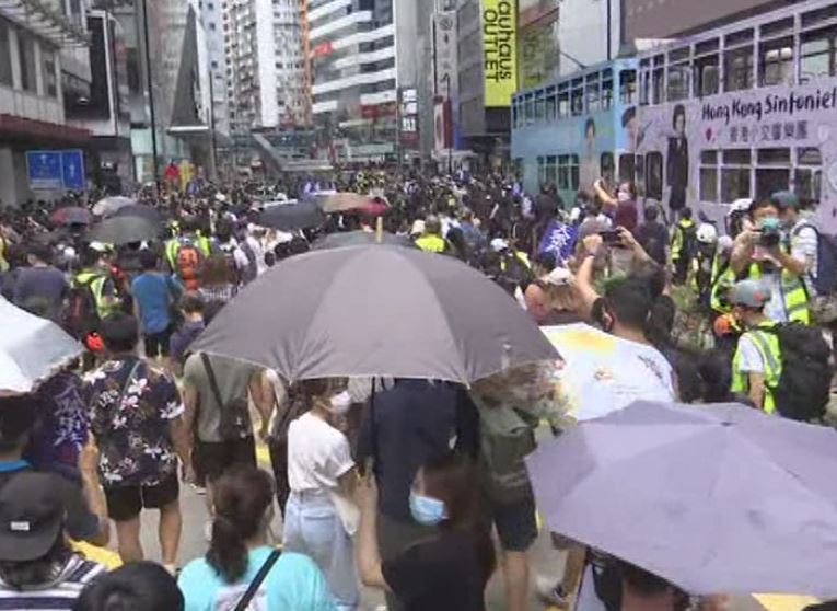 Hong Kong police fire volleys of tear gas at protesters