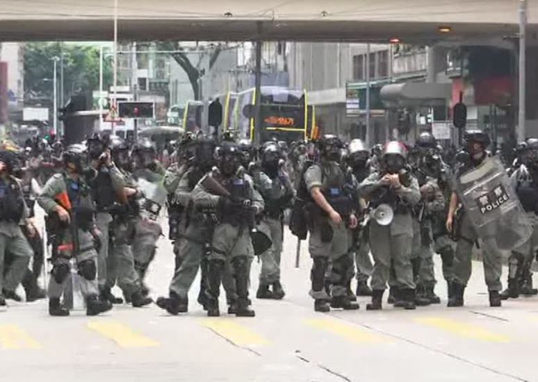 Hong Kong police fire volleys of tear gas at protesters