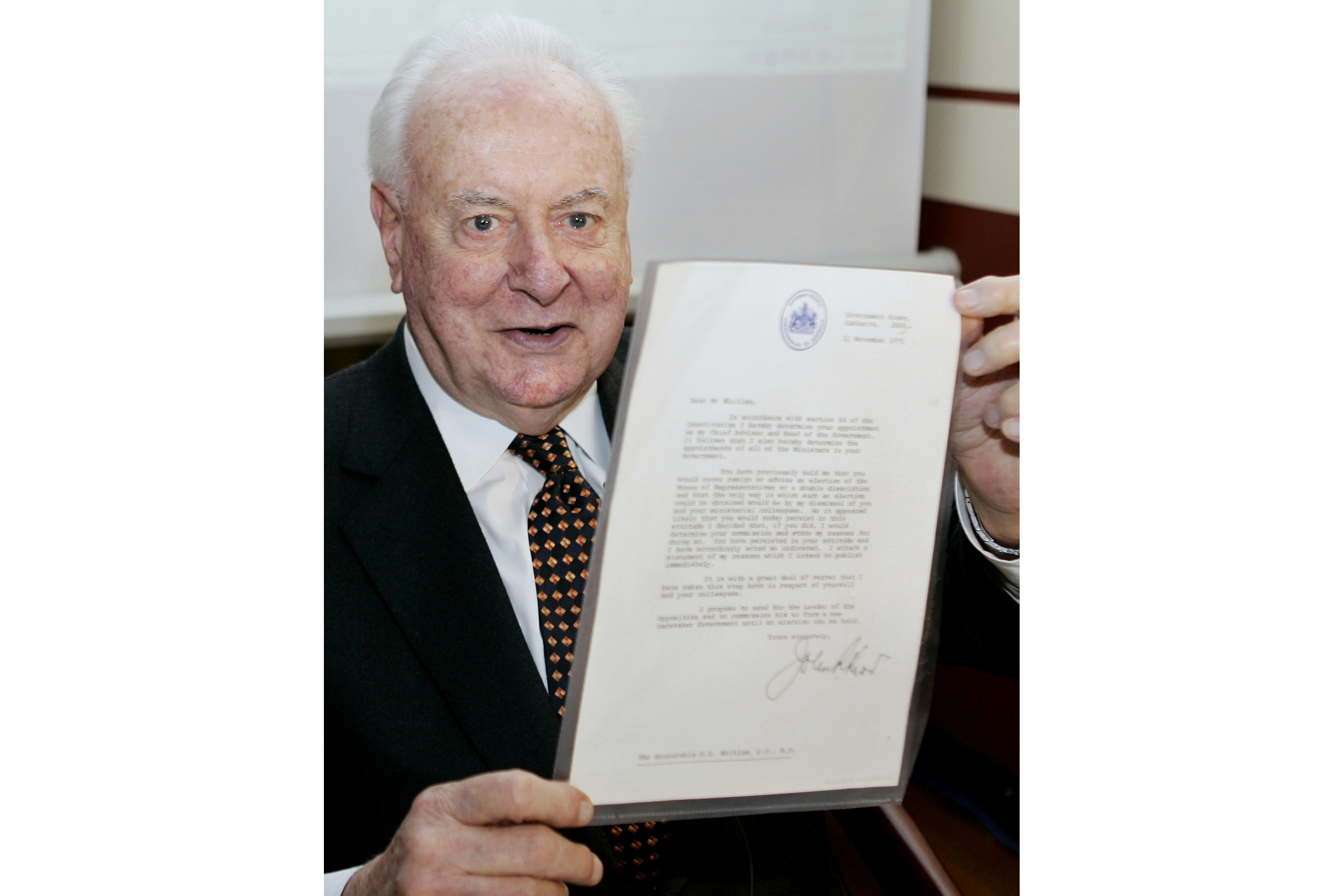 Former Australian prime minister Gough Whitlam holding up the original copy of his dismissal letter he received from then Governor-General Sir John Kerr on November 11, 1975, at a book launch in Sydney.