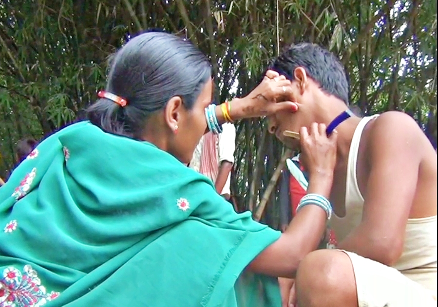 troubled by financial hardship, the woman is cutting hair and shaving