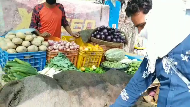 Customers at the vegetable shop