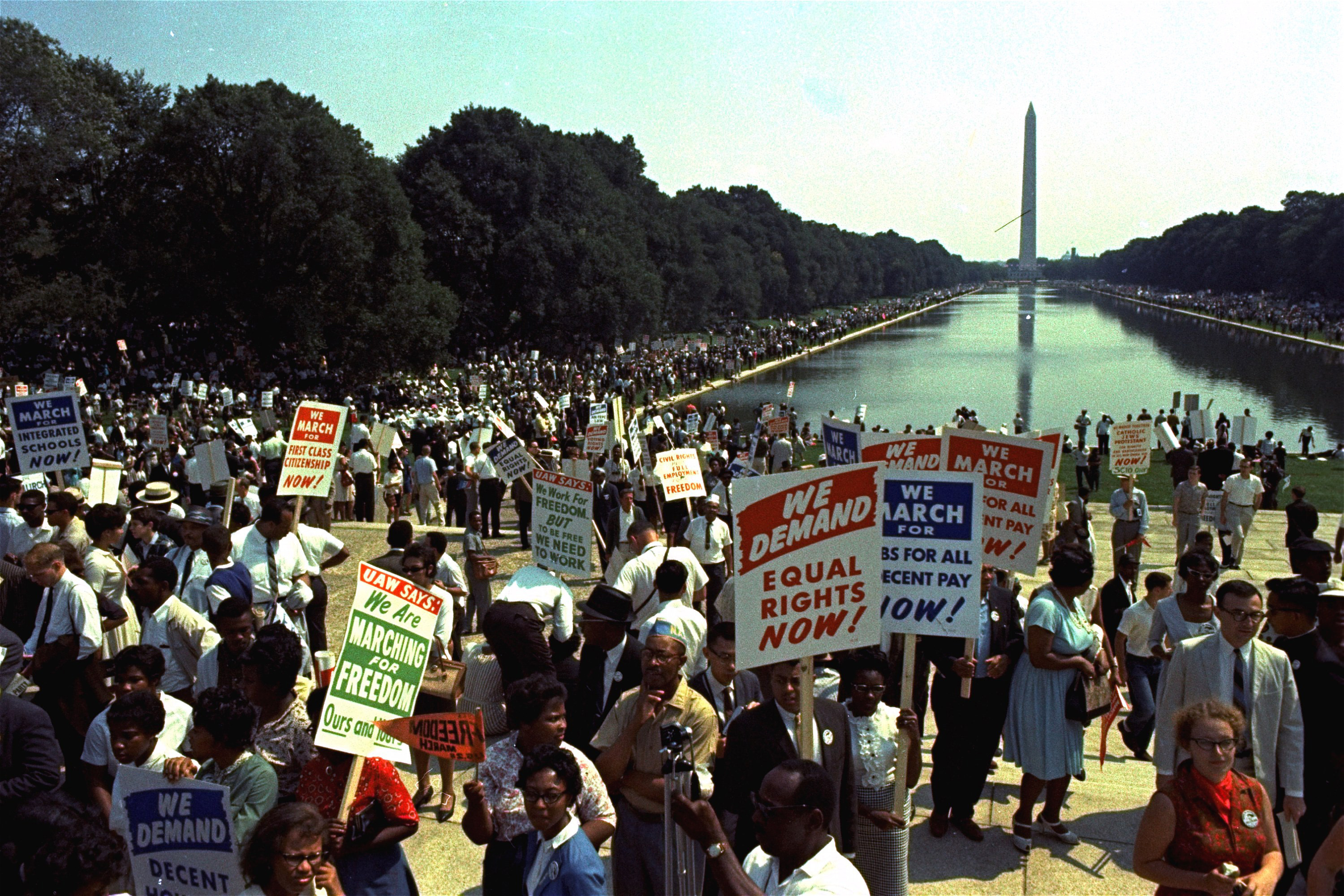 People carry civil rights signs as they gather in Washington before Martin Luther King Jr.'s 