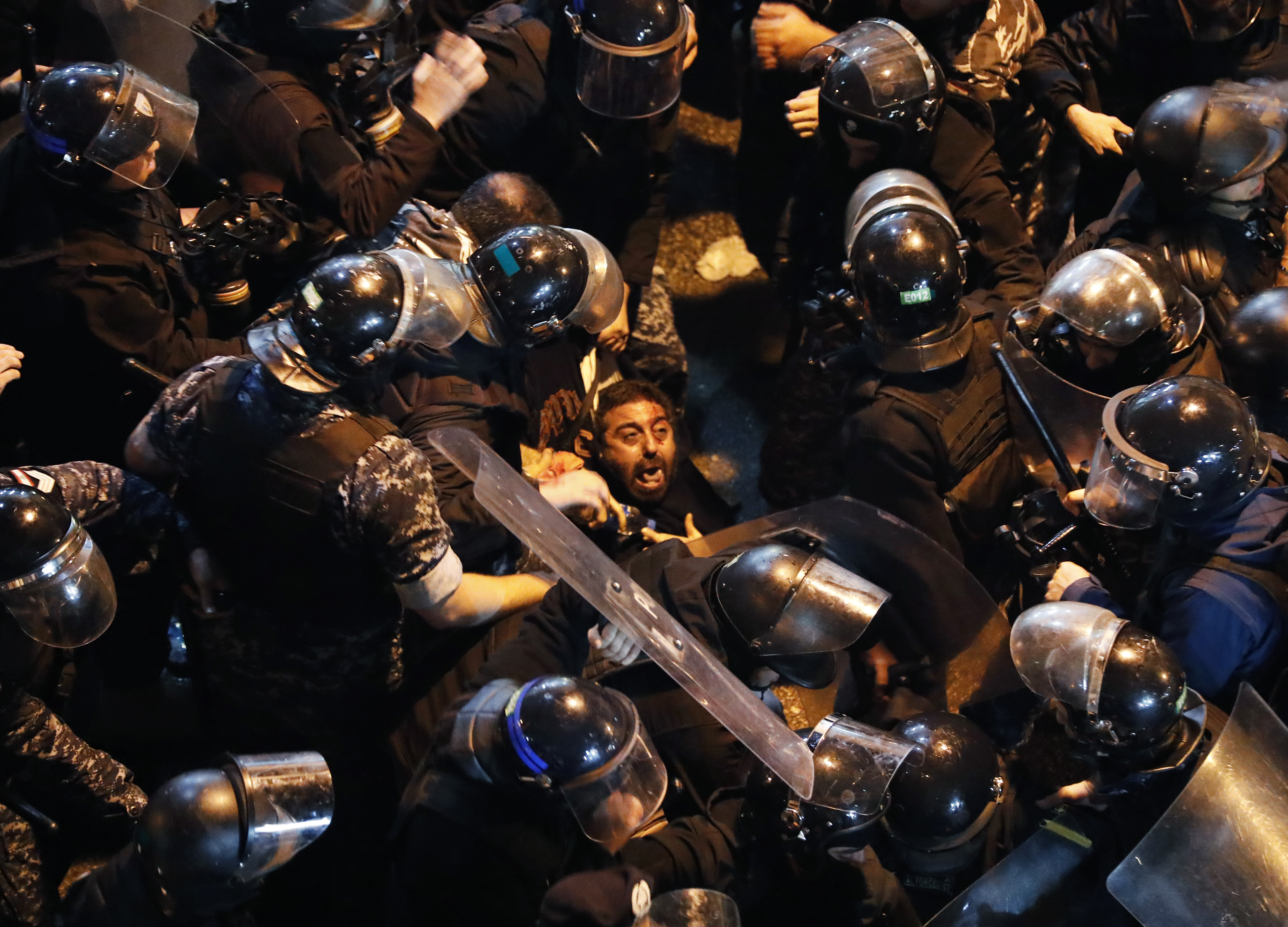 Riot police arrest an anti-government protester who was protesting outside a police headquarters demanding the release of those taken into custody the night before, in Beirut, Lebanon. (File pic)