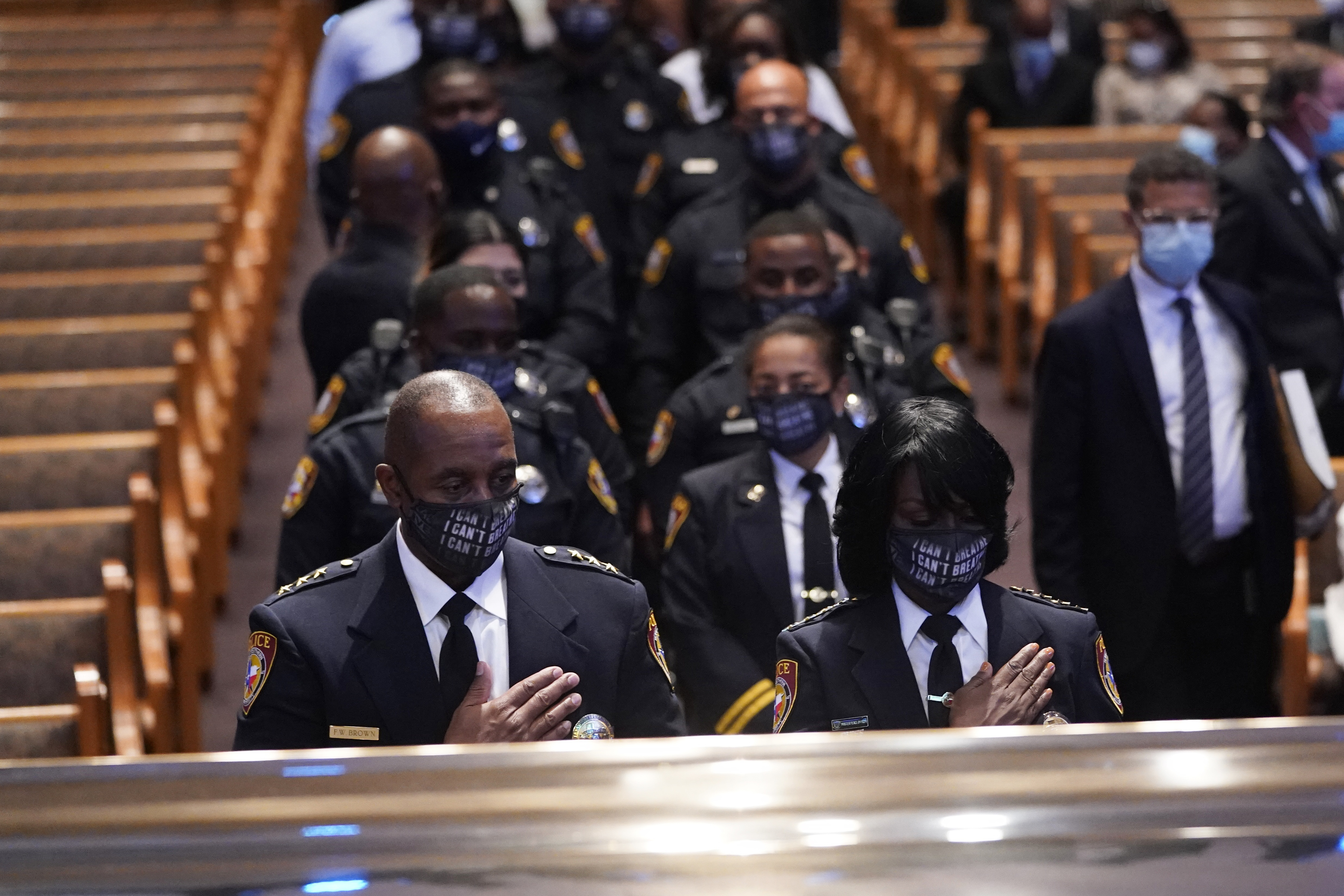 Members of the Texas Southern University police department pause during a funeral service for George Floyd at The Fountain of Praise church on Tuesday.