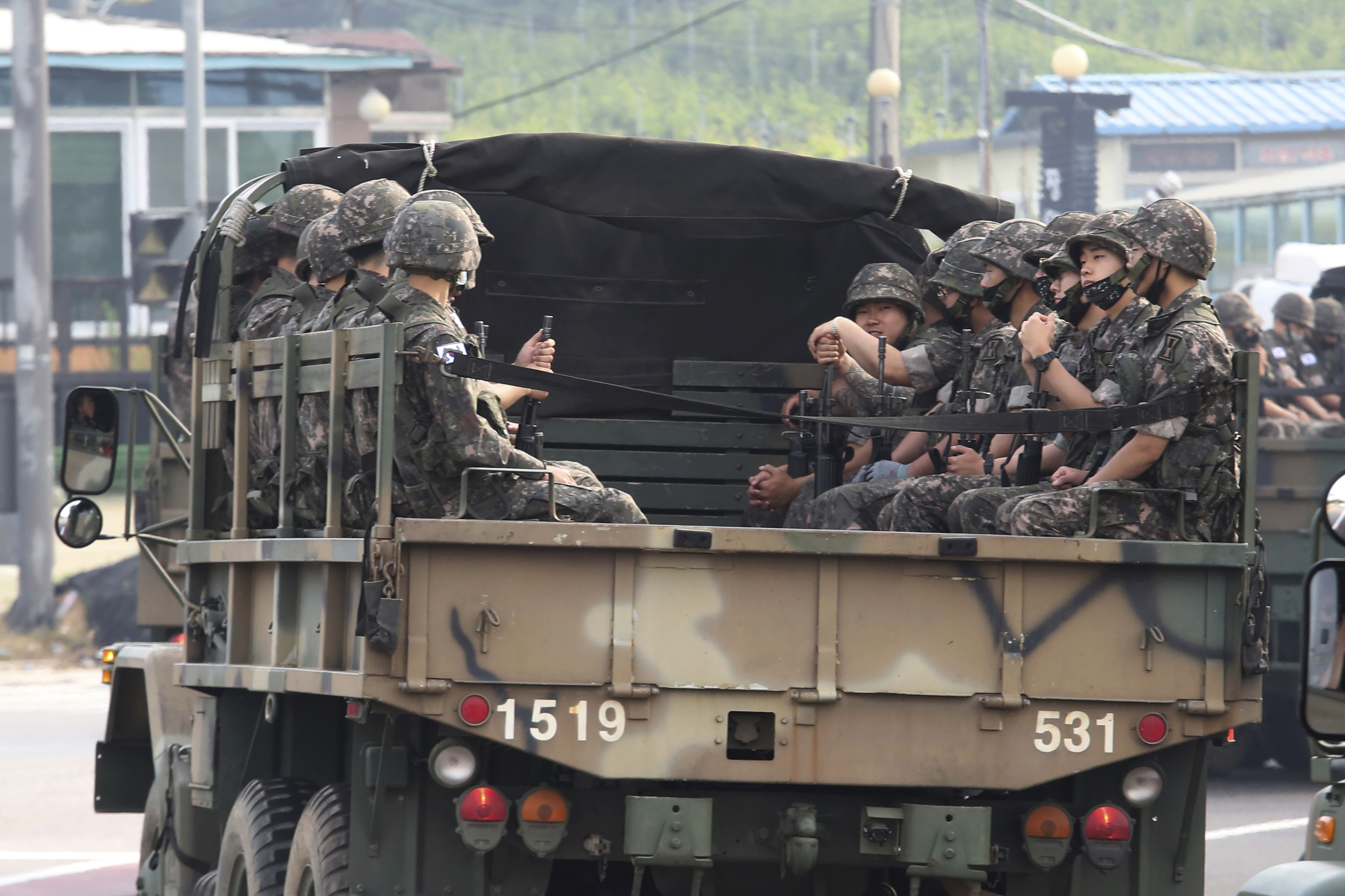 South Korean army soldiers ride on the back of trucks in Paju, near the border with North Korea, South Korea, on Wednesday.