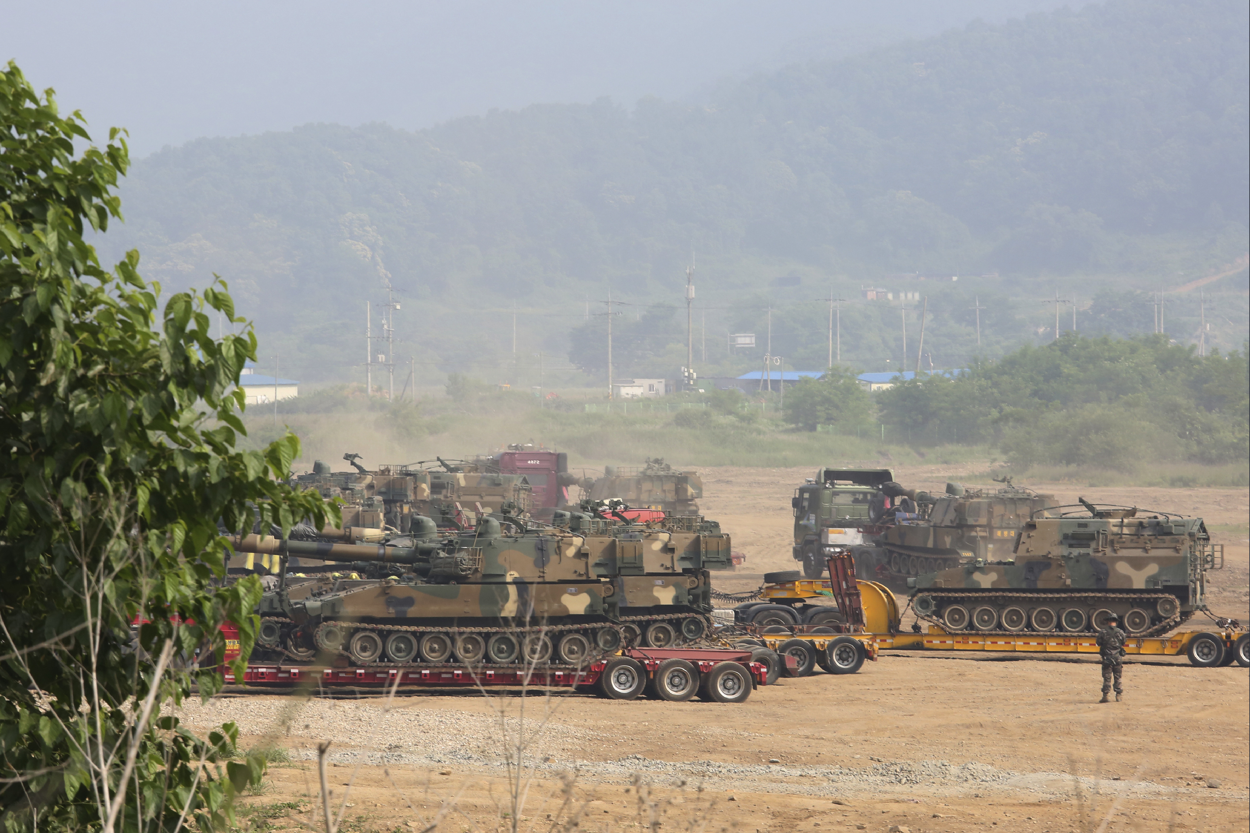 South Korean army's K-55 self-propelled howitzers loading on vehicles are moved in Paju, near the border with North Korea, South Korea, on Wednesday.