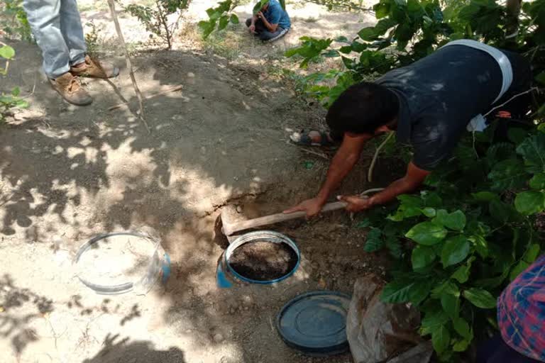 Police personnel while destroying Moha alcohol