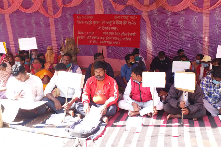 workers engaged in medical college construction work sit on strike in chaibasa