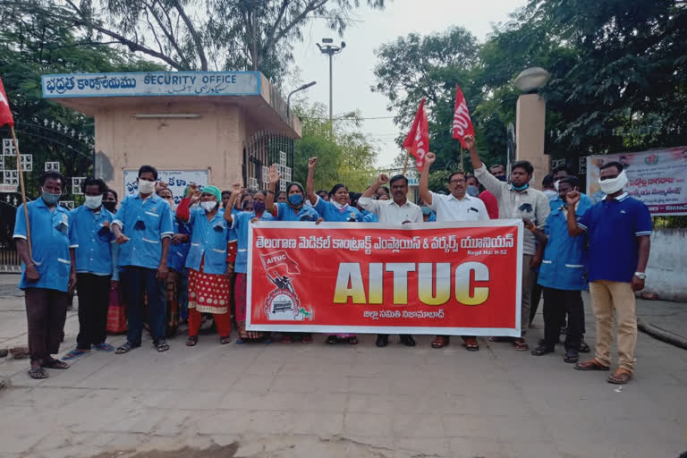 Government hospital workers staged a protest  in front of Nizamabad govt hospital.