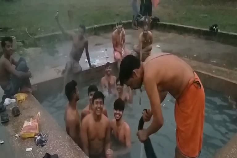 Tourists enjoy bathing in Atri hot spring on a winter morning