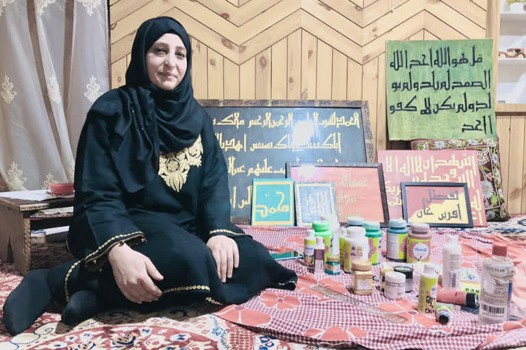 Calligrapher Farah Deeba while writing on the painting walls