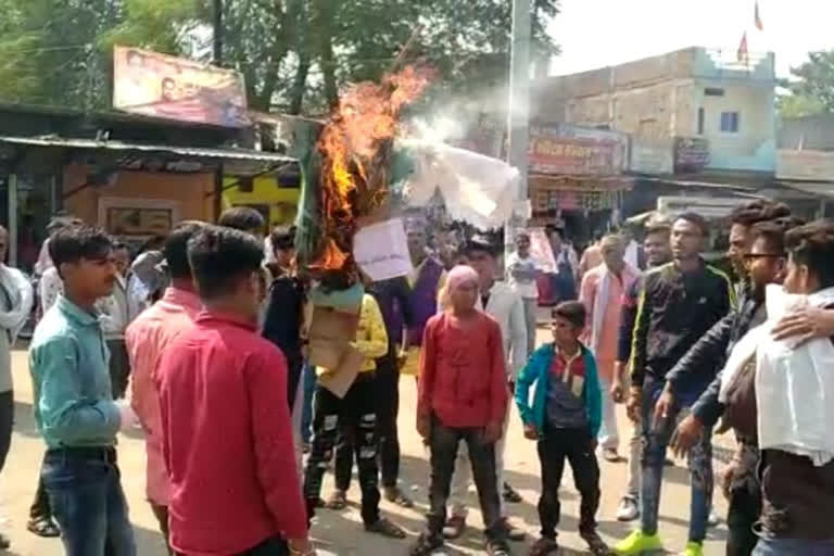 People burning effigy of education commissioner