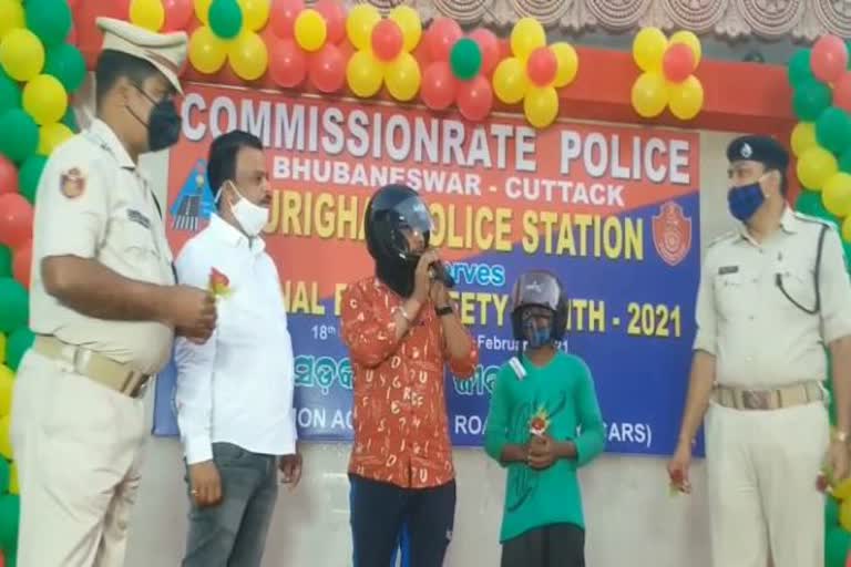 puri ghat police distribute helmet in road safety program