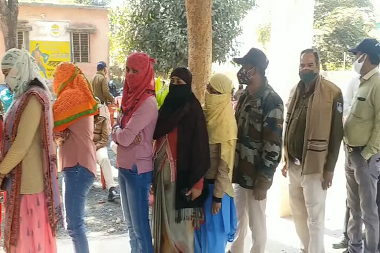 Policemen putting vaccine in line