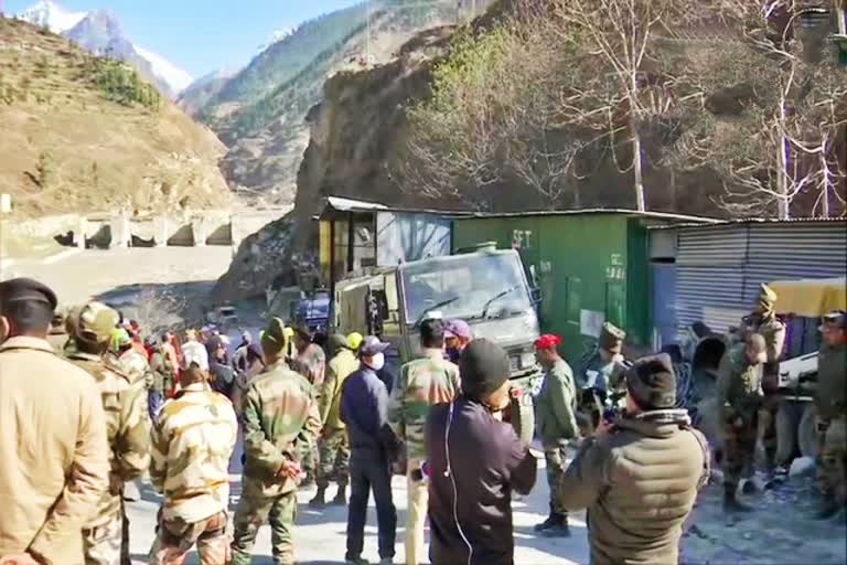 rescue teams exit the tunnel in Joshimath, Chamoli