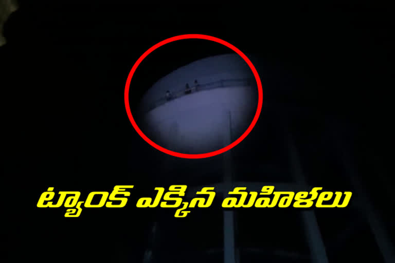 Women protest by climbing a water tank in Ambedkar Nagar, Karimnagar