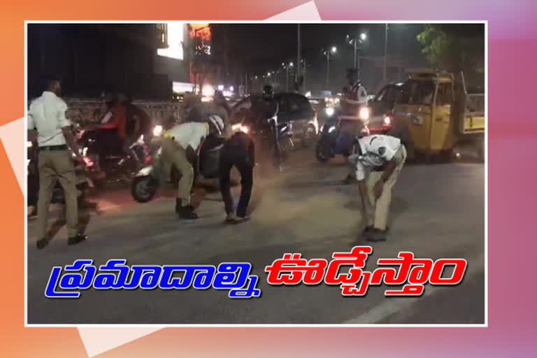 traffic police cleaning the road at banjara hills in hyderabad