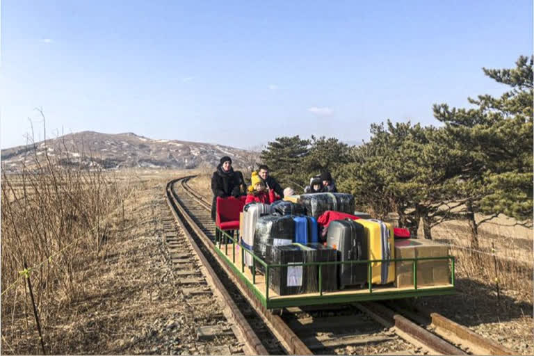 Russian diplomats hand-push trolley over North Korea border